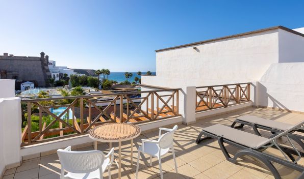 Terrace of the Gold Level Gran Suite with sun loungers, table and chairs