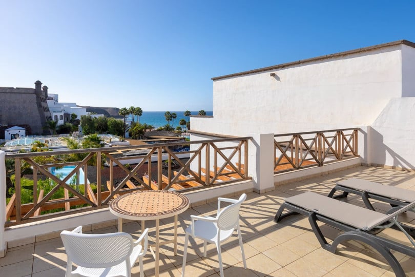 Terrace of the Gold Level Gran Suite with sun loungers, table and chairs